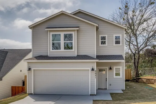 a front view of a house with a garage