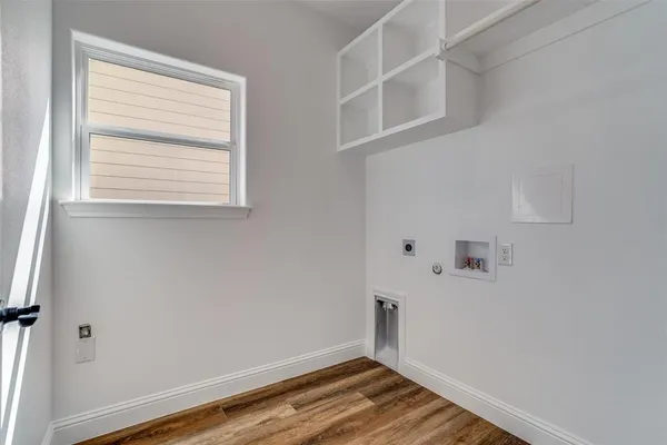 a view of a room with rack on the wall and a window