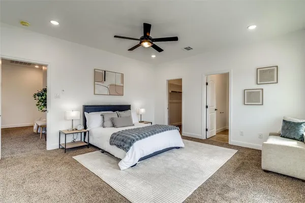 a bedroom with a bed and ceiling fan