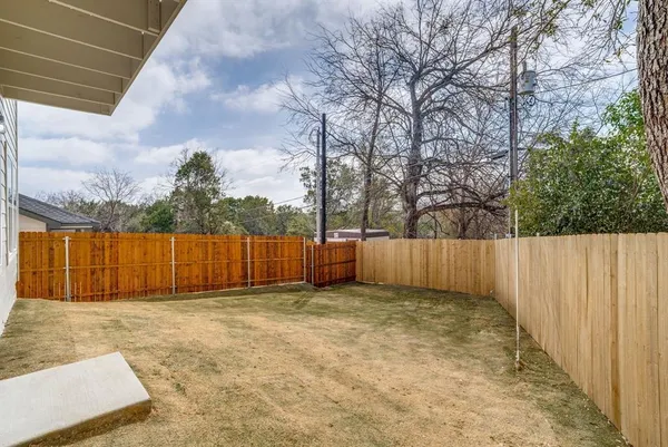 a view of backyard with a barn and wooden fence