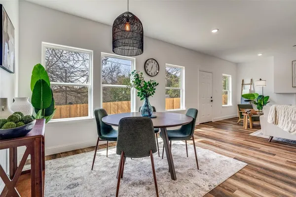 a view of a dining room with furniture window and wooden floor