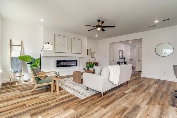 a living room with furniture and a wooden floor