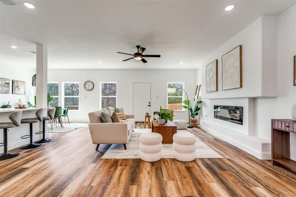 a living room with fireplace furniture and a wooden floor