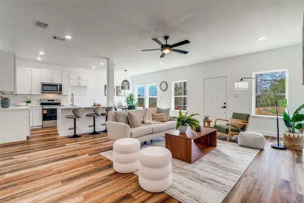 a living room with furniture and wooden floor