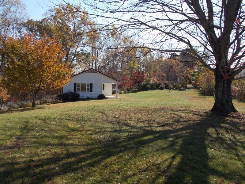 156 Rose Wood Road Woolwine, VA 24185 - Photo 6 of 29 a house with green field in front of it