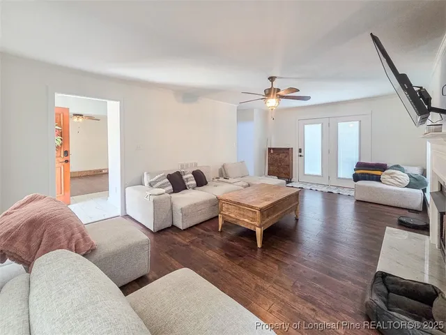 a living room with furniture and a chandelier