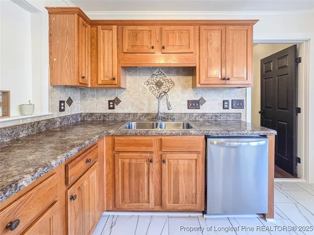 a kitchen with stainless steel appliances granite countertop a refrigerator sink and cabinets