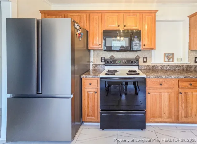 a kitchen with stainless steel appliances granite countertop a refrigerator and a stove