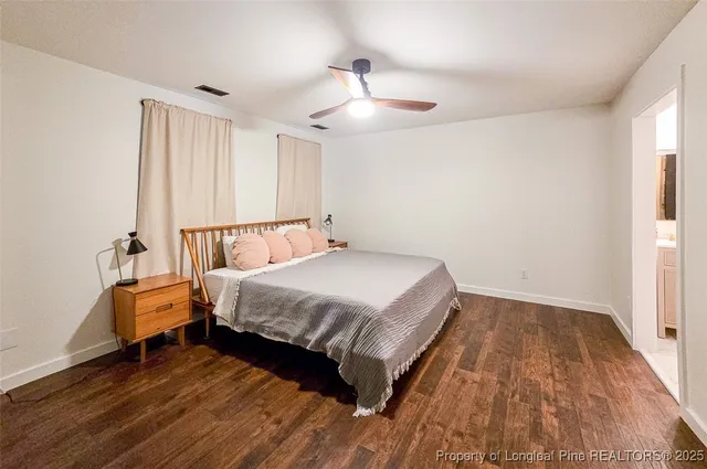 a spacious bedroom with a bed and a chandelier