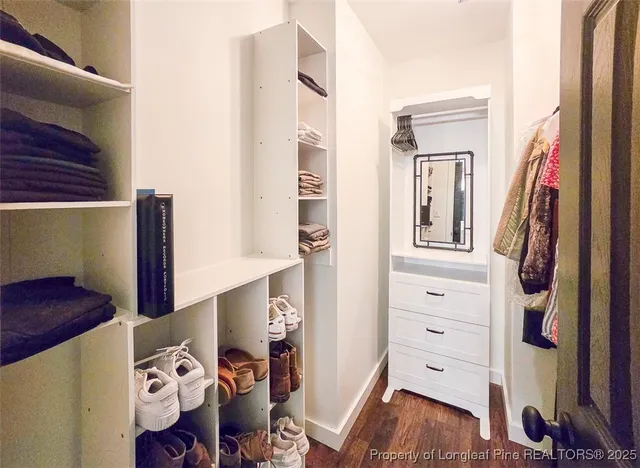 a view of a house with a big yard and large trees