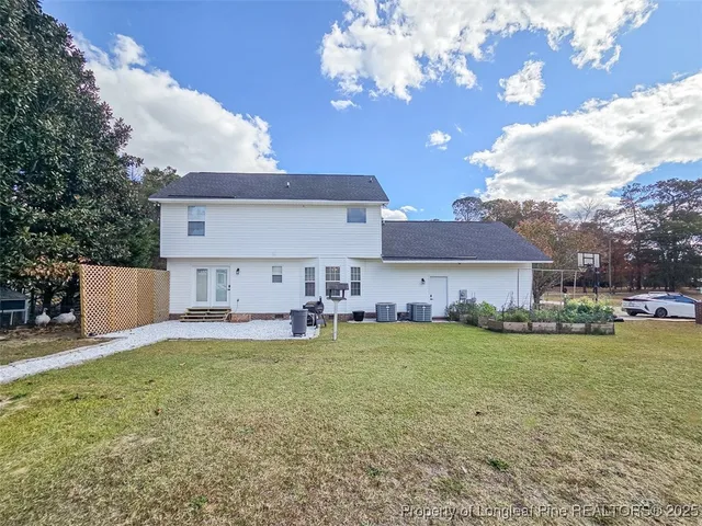 a view of a house with backyard and sitting area