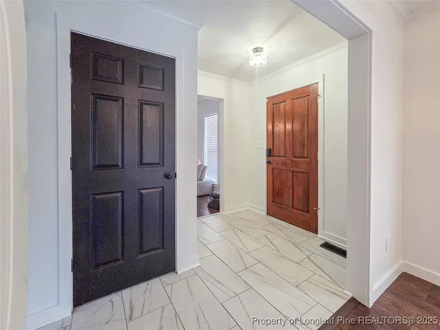 an empty room with closet and mirror