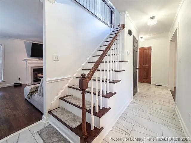 a view of entryway and hall with wooden floor