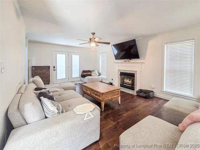 a living room with furniture a flat screen tv and a fireplace