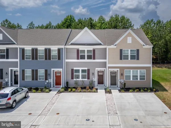 a aerial view of a brick house many windows and trees