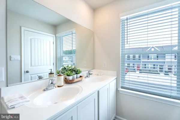 a bathroom with a sink and a large mirror