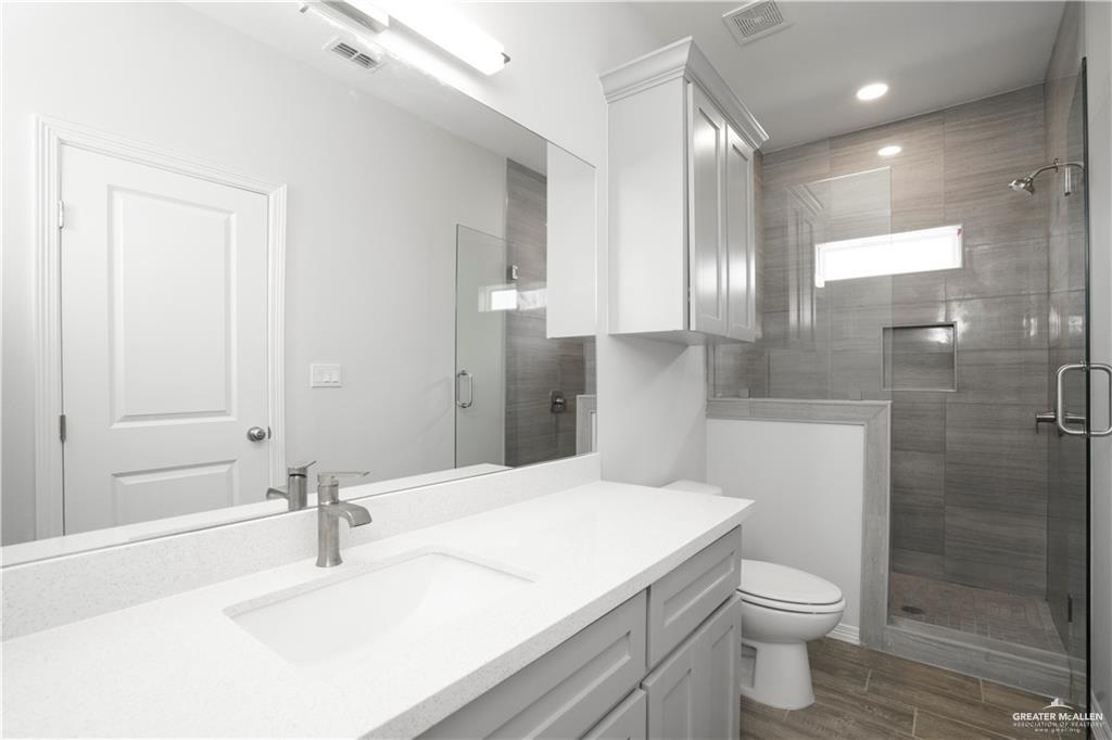 5900 Puffin Avenue, Unit 2 Mission, TX 78573 - Photo 11 of 32 a bathroom with a sink toilet and shower