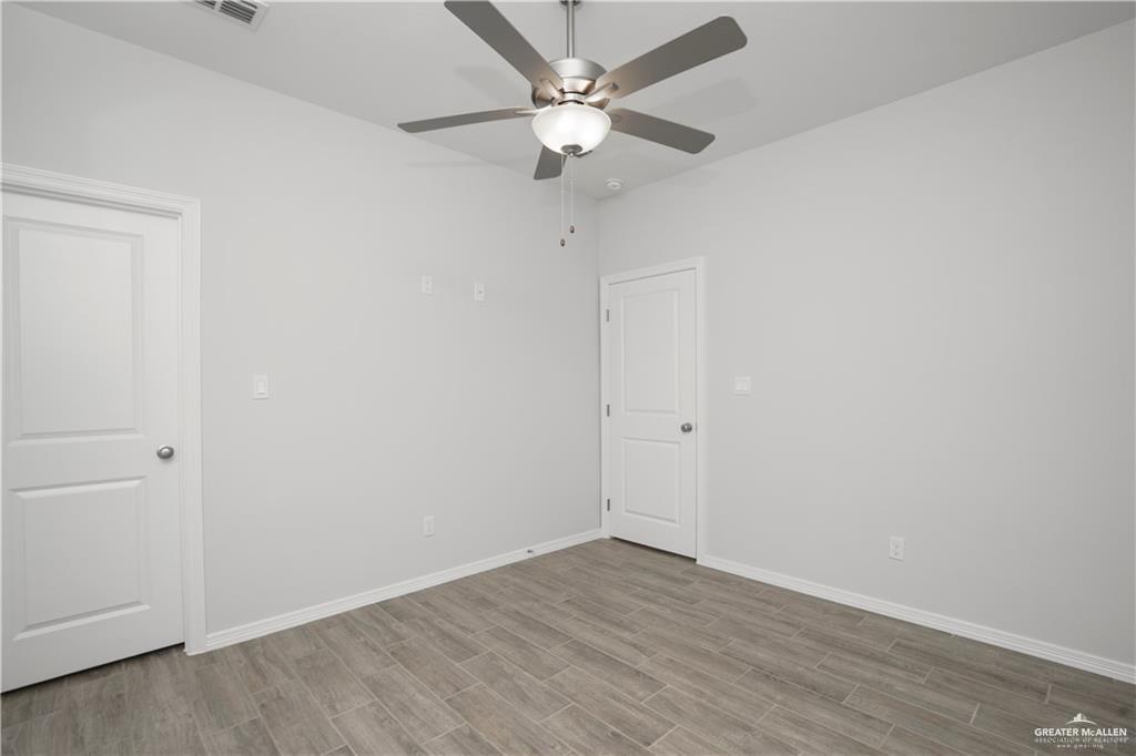 5900 Puffin Avenue, Unit 2 Mission, TX 78573 - Photo 12 of 32 a view of an empty room with a fan