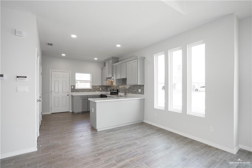 5900 Puffin Avenue, Unit 2 Mission, TX 78573 - Photo 5 of 32 a kitchen with a white wooden cabinets and white appliances