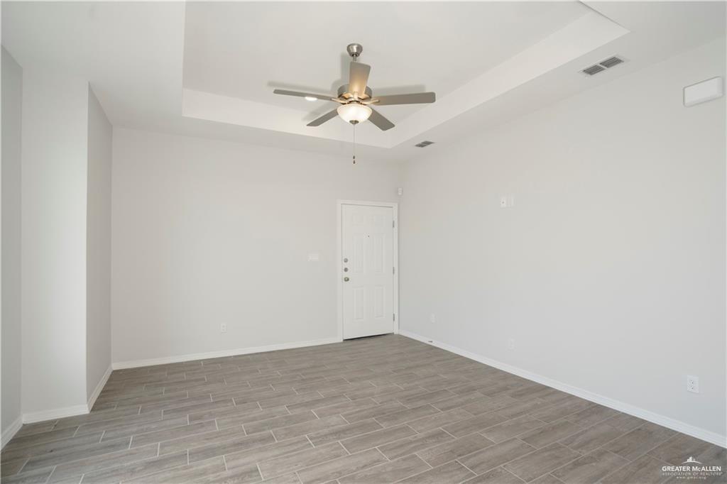 5900 Puffin Avenue, Unit 2 Mission, TX 78573 - Photo 8 of 32 wooden floor in an empty room