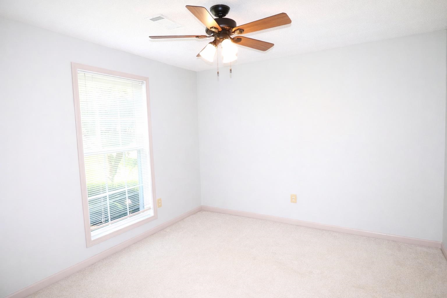 6708 Dawnhill Road Bartlett, TN 38135 - Photo 16 of 18 Carpeted room featuring a ceiling fan with light fixture, a single window with horizontal blinds, and neutral-toned wall paint