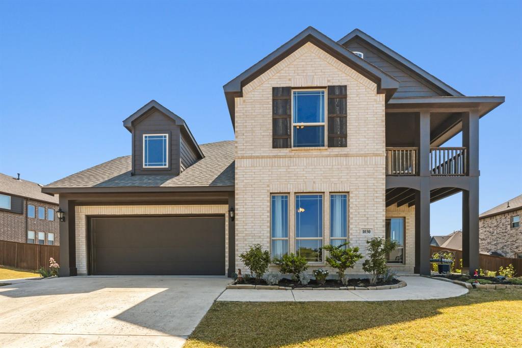 1030 Timber Ridge Drive Justin, TX 76247 - Photo 1 of 40 View of front of house with brick siding, driveway, a garage, roof with shingles, and a balcony