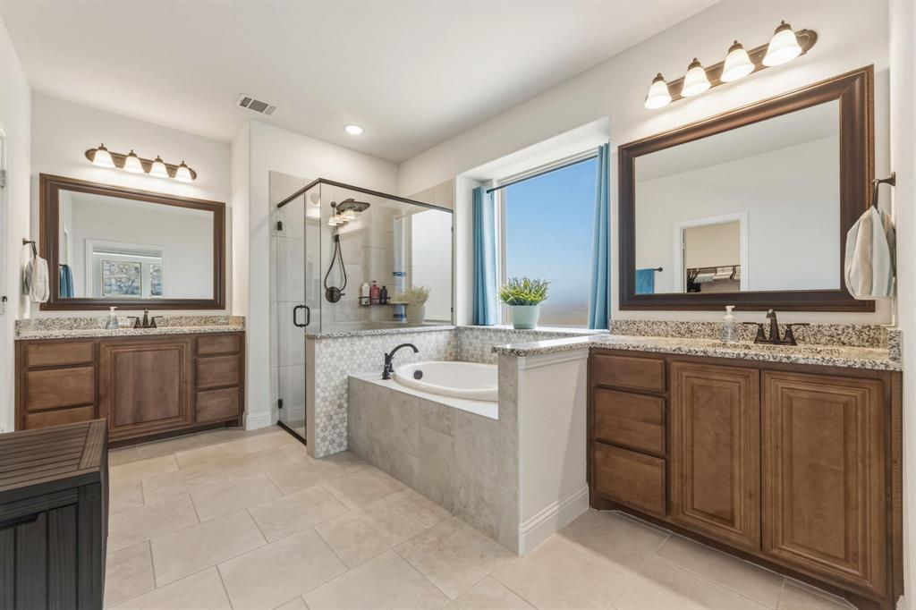 1030 Timber Ridge Drive Justin, TX 76247 - Photo 20 of 40 Full bath with two vanities, a shower stall, a bath, and light tile patterned floors