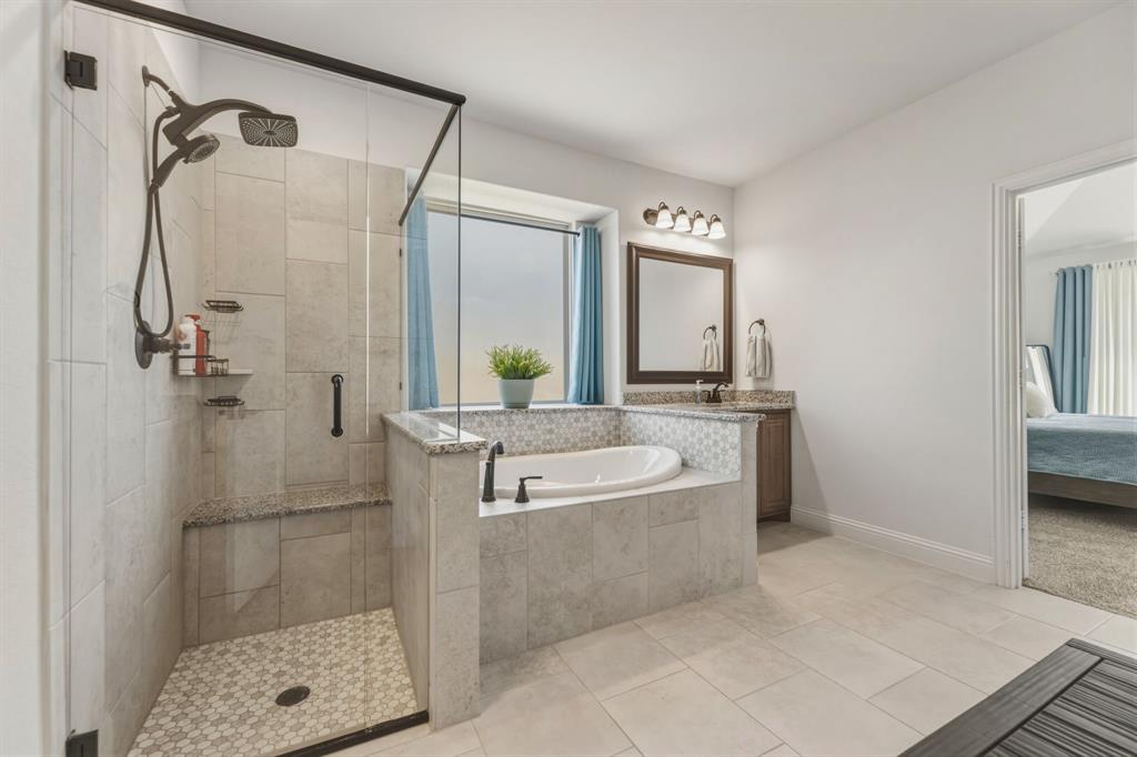 1030 Timber Ridge Drive Justin, TX 76247 - Photo 22 of 40 Ensuite bathroom featuring vanity, a bath, a stall shower, and light tile patterned floors