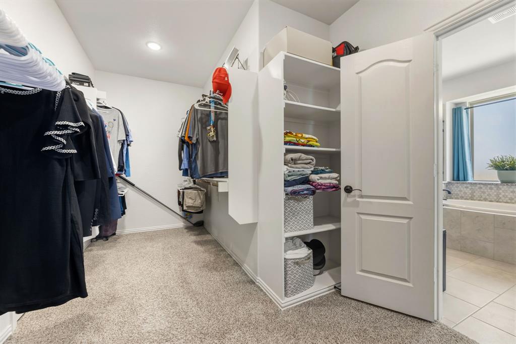 1030 Timber Ridge Drive Justin, TX 76247 - Photo 23 of 40 Walk in closet with light colored carpet and light tile patterned flooring