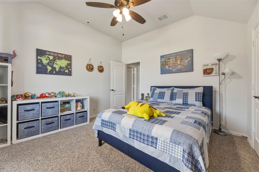 1030 Timber Ridge Drive Justin, TX 76247 - Photo 31 of 40 Bedroom featuring lofted ceiling, carpet floors, and ceiling fan