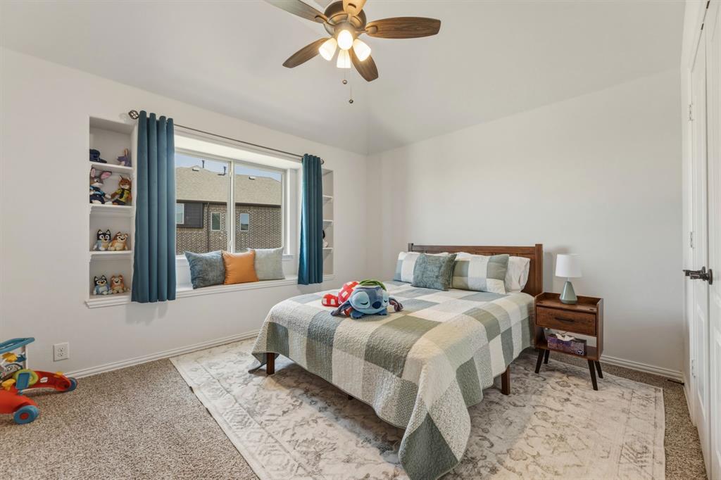1030 Timber Ridge Drive Justin, TX 76247 - Photo 33 of 40 Bedroom featuring light colored carpet, ceiling fan, and vaulted ceiling