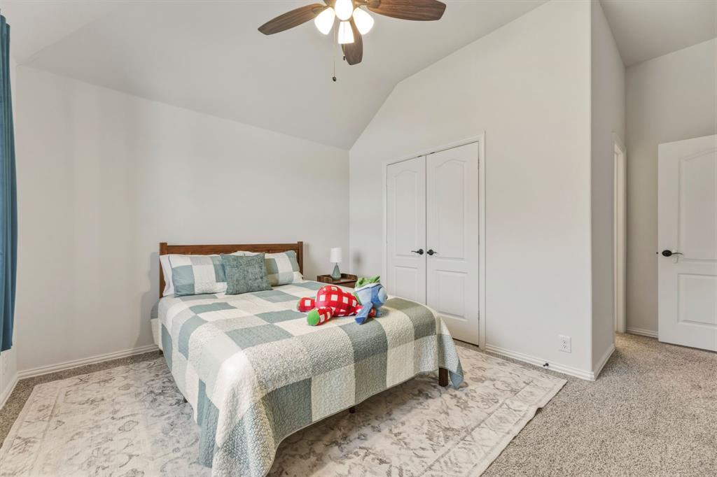 1030 Timber Ridge Drive Justin, TX 76247 - Photo 34 of 40 Bedroom featuring lofted ceiling, light colored carpet, a ceiling fan, and a closet
