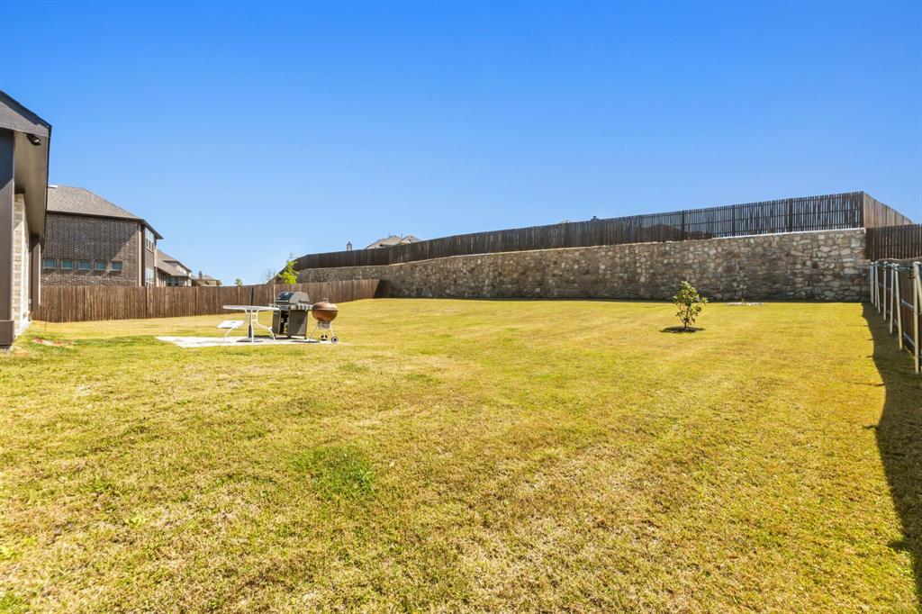 1030 Timber Ridge Drive Justin, TX 76247 - Photo 35 of 40 Fenced backyard featuring a patio