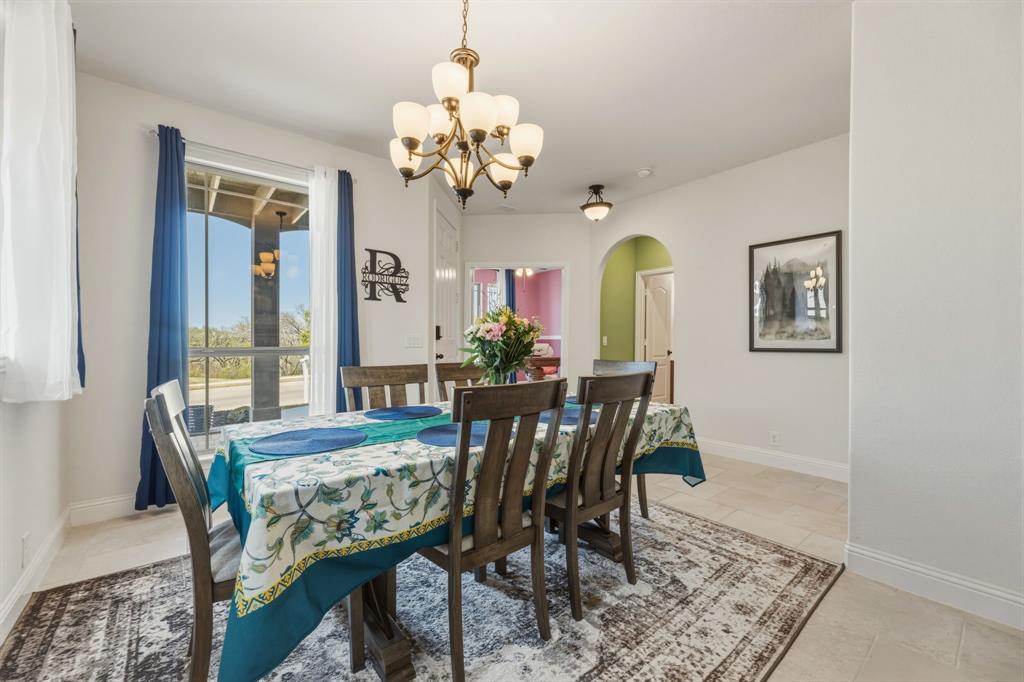 1030 Timber Ridge Drive Justin, TX 76247 - Photo 5 of 40 Dining space with arched walkways and hanging lights