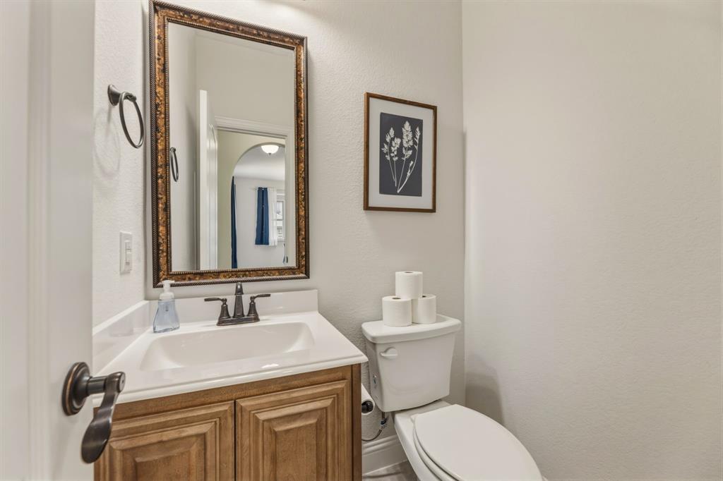 1030 Timber Ridge Drive Justin, TX 76247 - Photo 6 of 40 Half bath featuring vanity and a textured wall