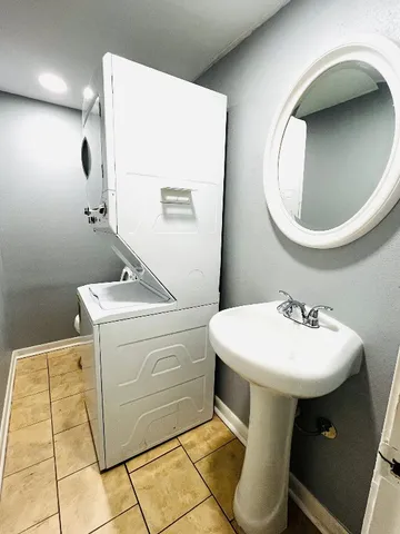 a bathroom with a sink toilet and mirror