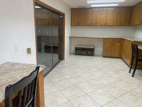 a kitchen with granite countertop a sink cabinets and stainless steel appliances