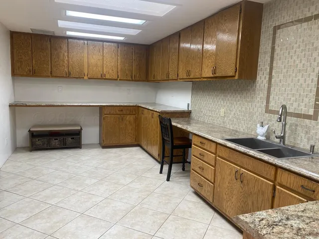 a kitchen with stainless steel appliances granite countertop a sink and cabinets