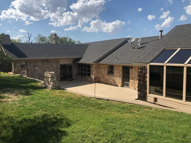 a backyard of a house with table and chairs
