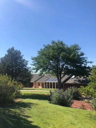 a front view of a house with a garden