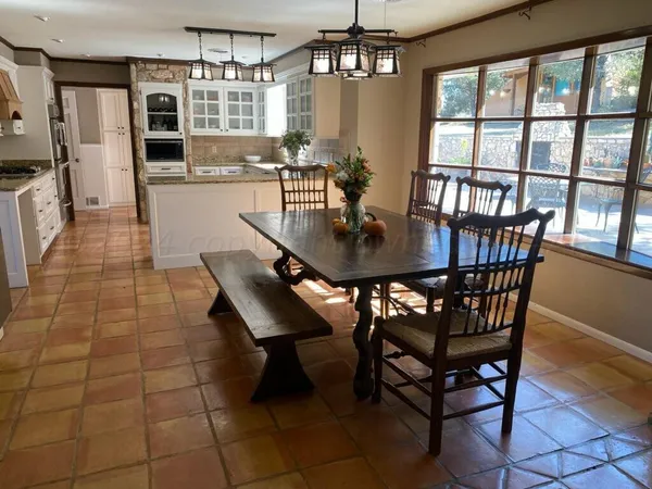 a view of a dining room with furniture and window