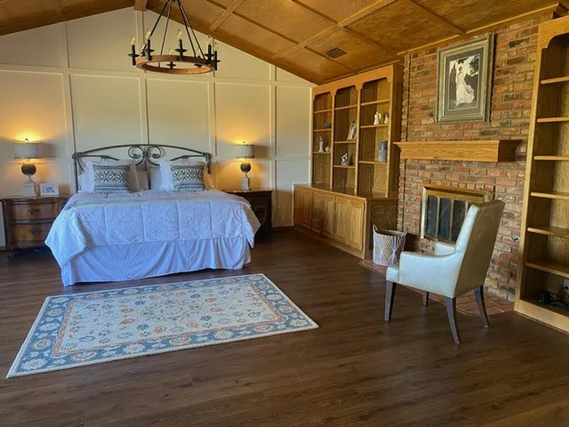 a bedroom with furniture and wooden floor
