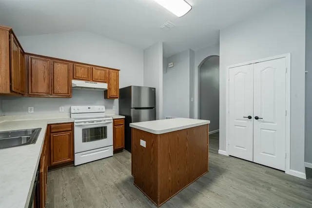 a kitchen with a stove and a refrigerator