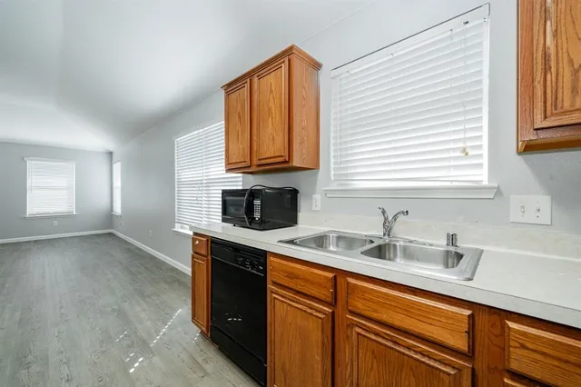 a kitchen with stainless steel appliances granite countertop a sink stove and cabinets