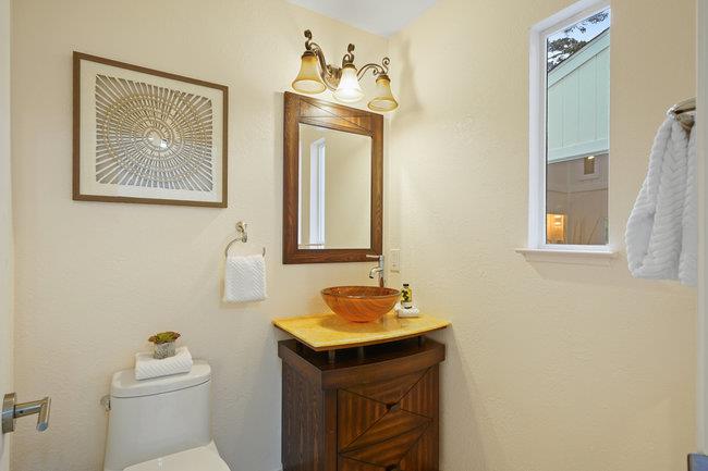 4076 Crest Road Pebble Beach, CA 93953 - Photo 23 of 46 a bathroom with a sink a toilet and mirror