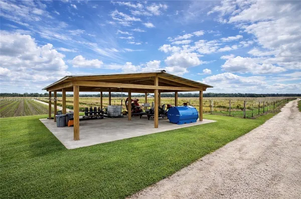a view of patio with a table and chairs under an umbrella