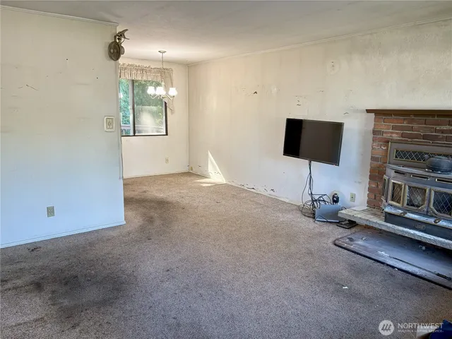 an empty room with furniture and a flat screen tv