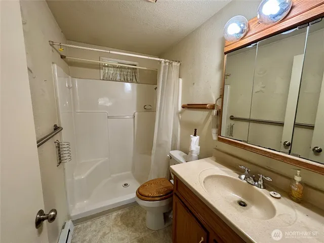 a bathroom with a sink toilet and shower