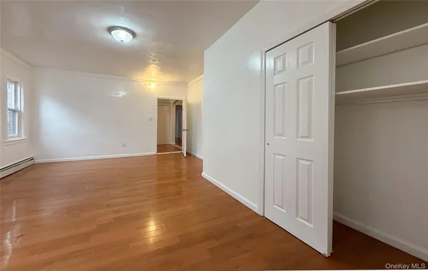 a view of hallway with wooden floor
