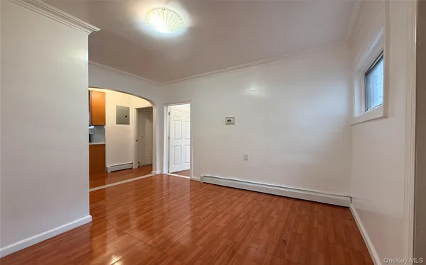 wooden floor in an empty room with a window